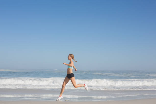 istock Fit woman jogging on the beach 690183956