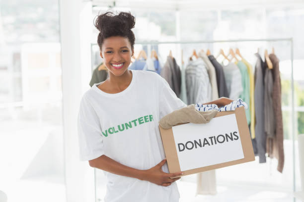 istock Smiling young woman with clothes donation 690190156