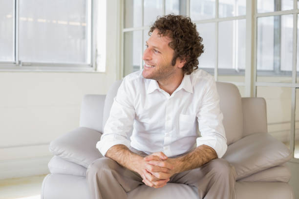 istock Relaxed well dressed man sitting at home 690191050
