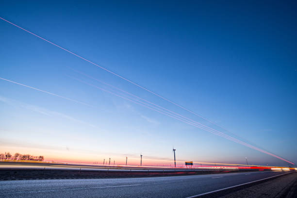 wind turbines at sunset along highway morning commute