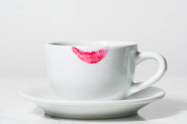 Close-up of red lipstick on a coffee cup. stock photo