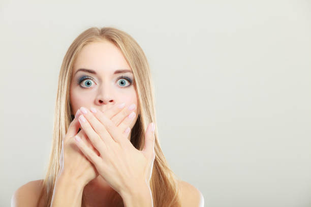 istock Amazed woman covering her mouth with hands 690198552