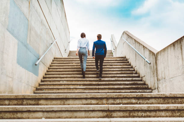 istock Two businesspeople outdoors going up staircase 690201504
