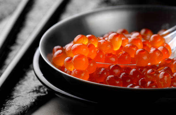 Close up shot of red caviar to be served with a wood spoon