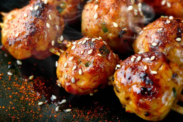 japanese meatball grill  or tsukune cooked with teriyaki sauce ready to eat photo in studio lighting.