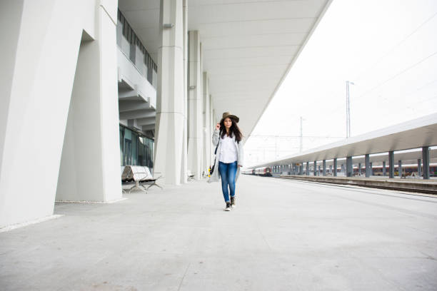 istock Woman in a train station 690202474