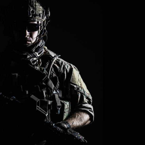 US Army Ranger close-up Elite member of US Army rangers in combat helmet and dark glasses. Studio shot, dark black background, looking at camera, dark contrast special forces photos stock pictures, royalty-free photos & images