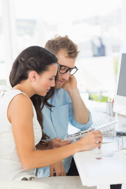 istock Team of designers working together at desk 690218260