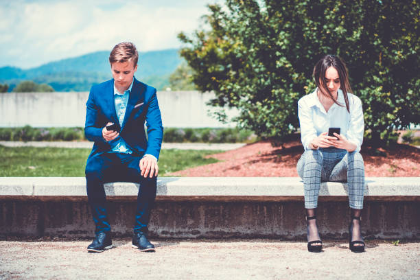 istock Two business people using smart phones outdoor 690219724