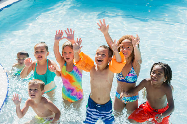 istock Multi-ethnic group of children playing in swimming pool 690223374