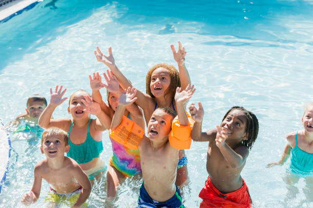 istock Multi-ethnic group of children playing in swimming pool 690223380