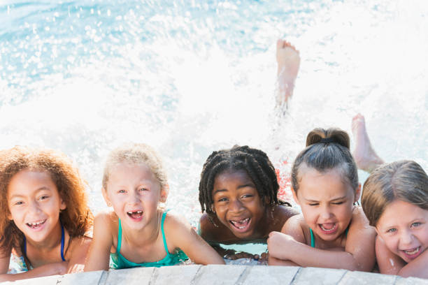 istock Multi-ethnic group of children in swimming pool laughing 690223508