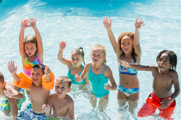 istock Multi-ethnic group of children playing in swimming pool 690223754