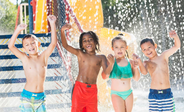 istock Multi-ethnic children at a water park dancing 690223760