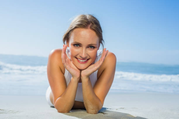 istock Fit smiling woman lying on the beach 690224362