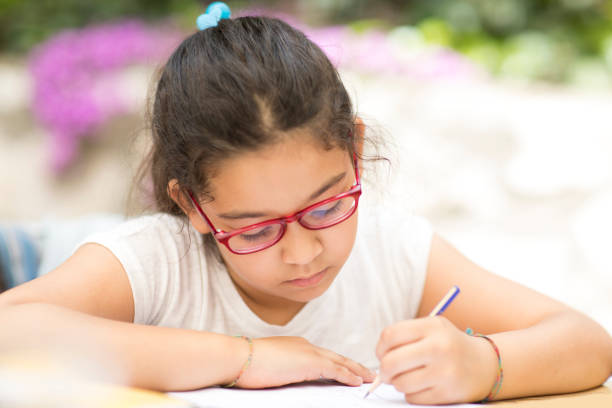 istock Little hispanic Girl Studying 690227860