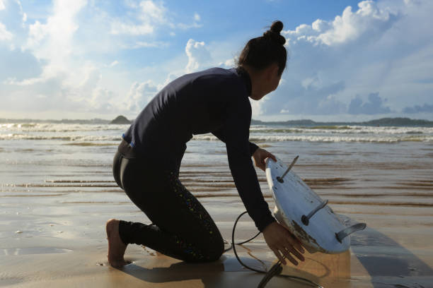 istock young woman surfer ready to surf on a beach 690228114