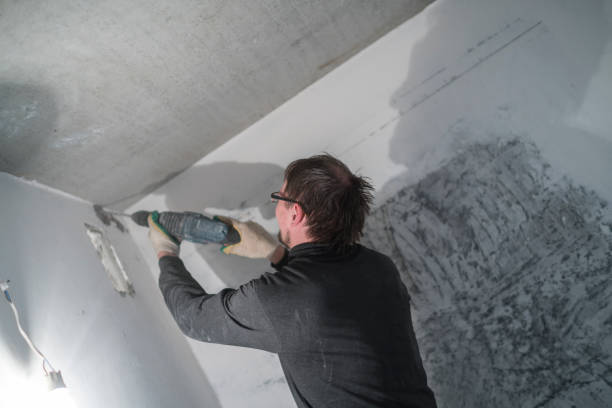istock Manual construction worker drilling the wall with the rock-drill 690228206