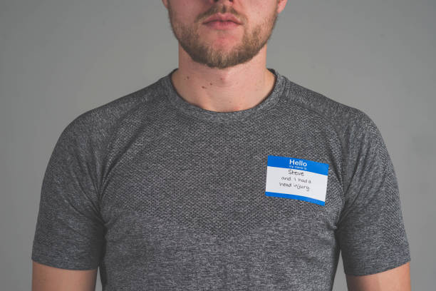 istock Man facing audience with name tag that describes struggle 