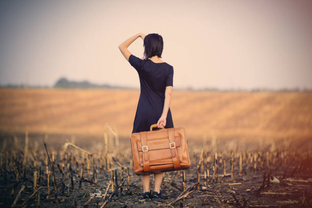istock young woman with suitcase 690229342