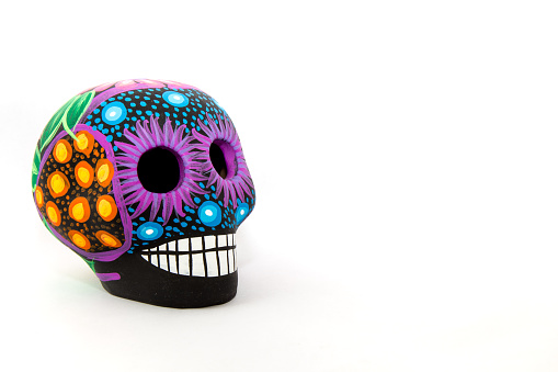 A Mexican black and neon colors skull, with a white background