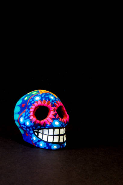 istock Mexican colorful skull with black background 690231976