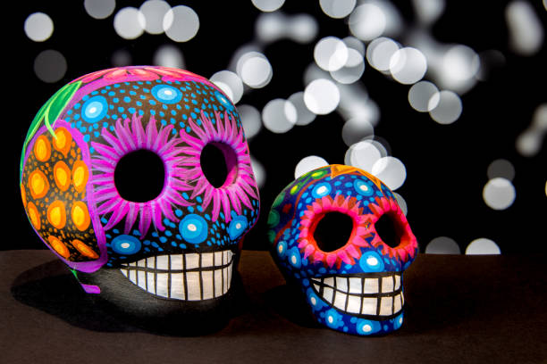 istock Mexican colorful skulls with black bokeh background 690231984