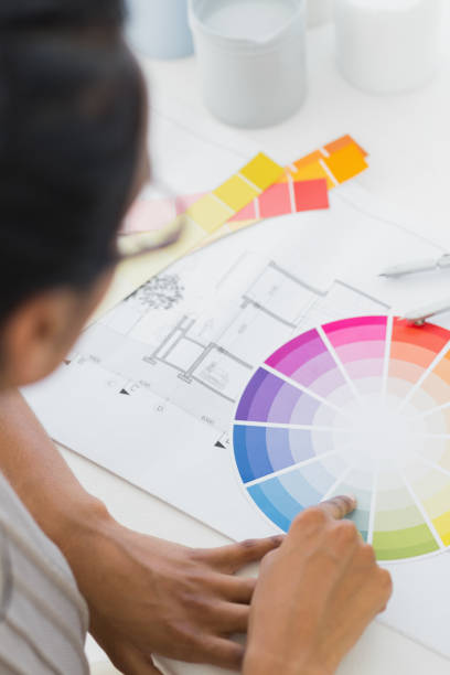 istock Interior designer looking at colour wheel at her desk 690235938