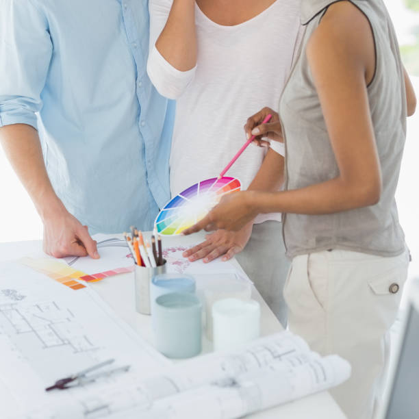 istock Interior designer showing colour wheel to client 690235994