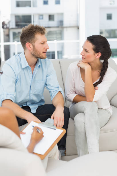 istock Unhappy couple talking at therapy session 690236174