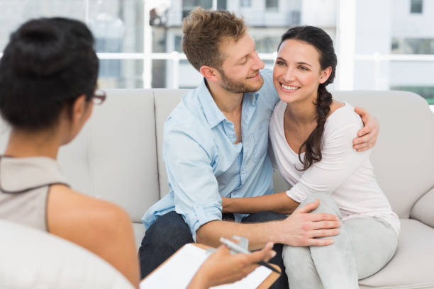 istock Happy couple reconciling at therapy session 690236182