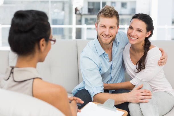istock Smiling couple reconciling at therapy session 690236188