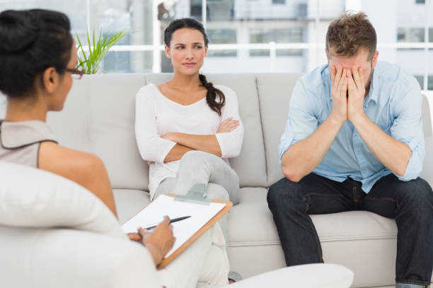 istock Unhappy couple sitting on sofa at therapy session 690236202
