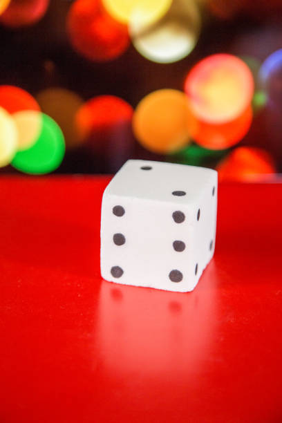 salt dice (number 6), with colorful bokeh as background