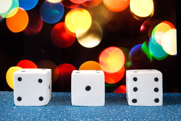 istock Three salt dices (number 4,1,6), with colorful bokeh as background 690239238