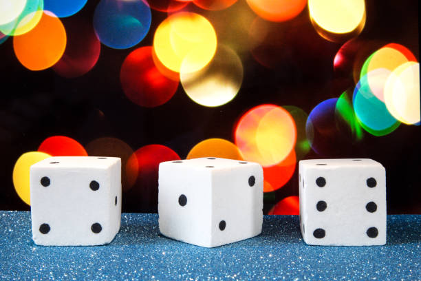 istock Three salt dices, with colorful bokeh as background 690240100