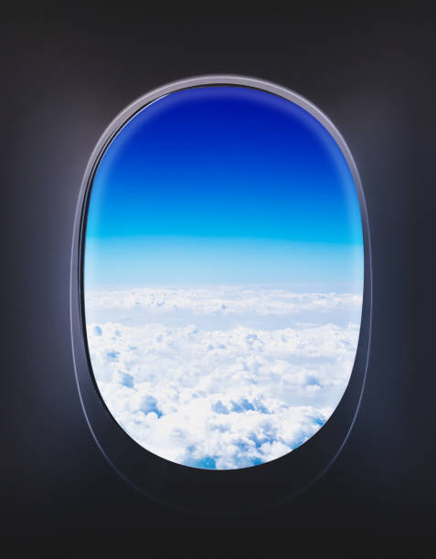 istock airplane window when flying see through at cloud and blue sky,Transportation concept 690243852