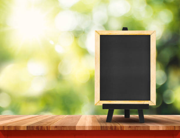 istock Empty brown wood table top with sun and blur green tree bokeh background, Template mock up for montage of product 690243878