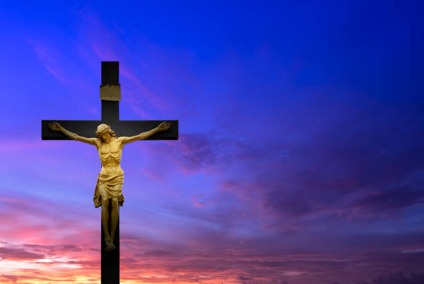 istock Christian cross over beautiful sunset background 690243984