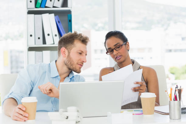 istock Partners working together on laptop at desk 690244564
