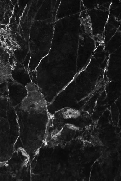 istock Black and dark marble texture shot through with white deep veining 690251220