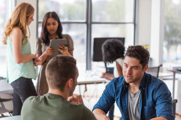 istock Young Business People Having a Discussion 690254316