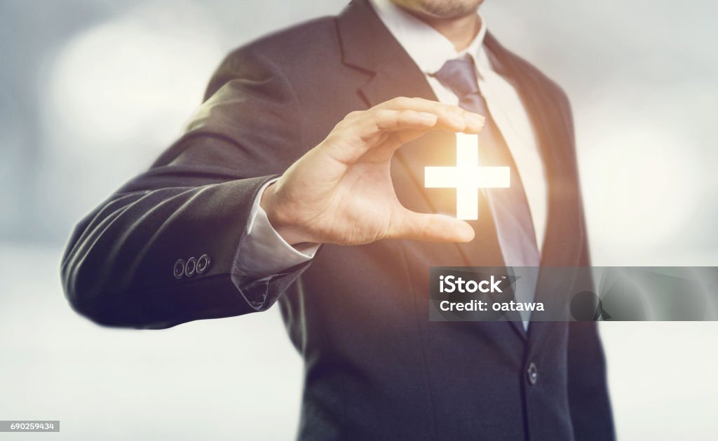 Businessman offer positive thing Businessman offer positive thing (such as profit, benefits, development, CSR) represented by plus sign. Adult Stock Photo