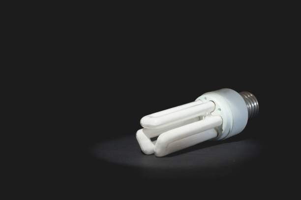 istock Light bulbs on wooden table., dark background. 690269952
