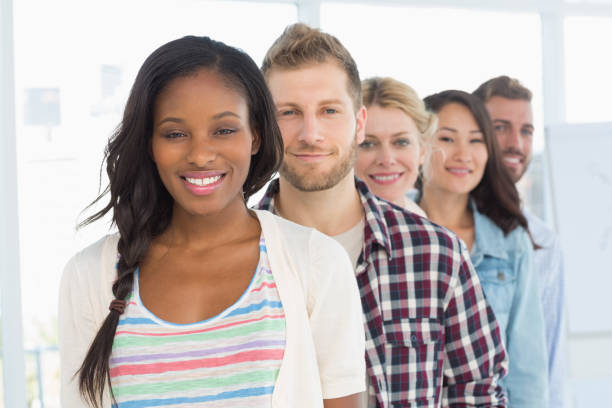 istock Diverse design team standing in a line smiling at camera 690270212