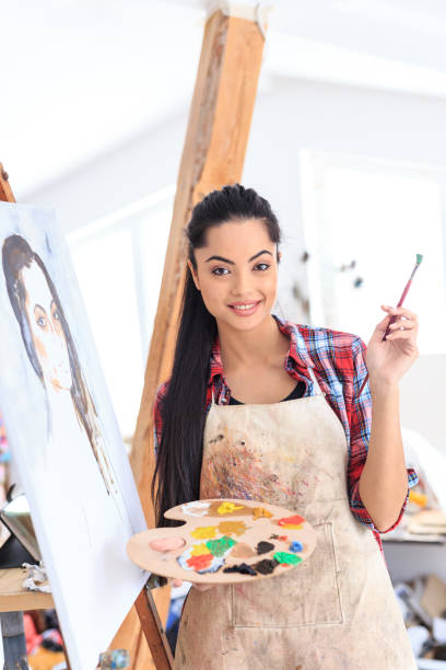 istock Young woman drawing in art studio 690277200