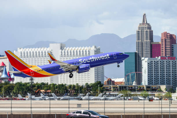 Las Vegas Hotel Casino Buildings with airplane taking off in the foreground Las Vegas, USA - March 25,2017: Telephoto shot of Buildings of Las Vegas Hotel & Casino. Passenger jet airplane taking off from Mccarran International Airport  in the foreground .Las Vegas is world famous for night entertainment show and convention center. luxor las vegas stock pictures, royalty-free photos & images