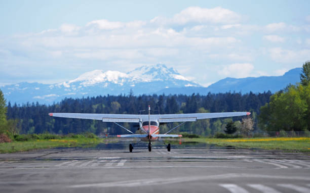 istock Small Airplane Taking Off in Front of a Mountain 690280398