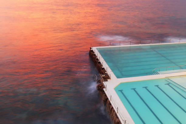 Bondi pool Sunrise Bondi Icebergs pool at red sunrise bondi beach sunrise stock pictures, royalty-free photos & images
