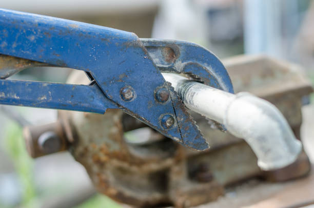 istock Old blue wrench unwind elbow from pipe, close up 690284454